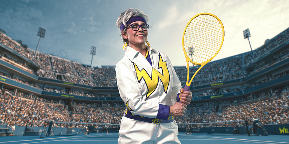 Granny holding a tennis racket and smiling.